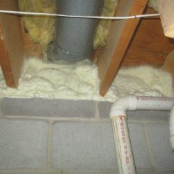 Spray foam is an effective thermal barrier being used along an unfinished basement band joist