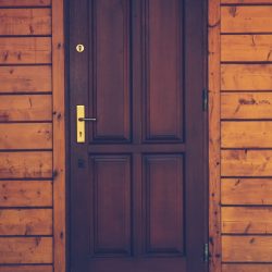 black wooden 4-panel door closed